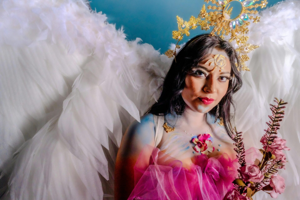 Elegant portrait of a woman with angel wings and artistic makeup in Mexico City.